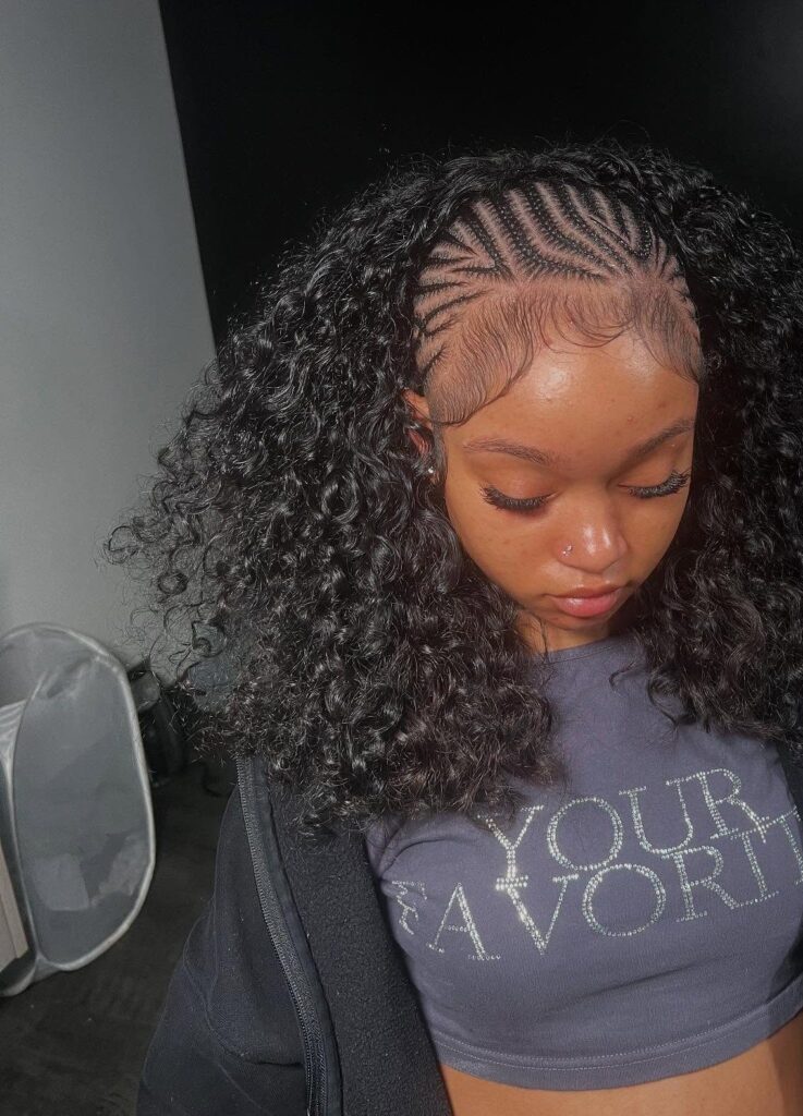 Woman with cornrow braids in the front and voluminous curly hair in the back