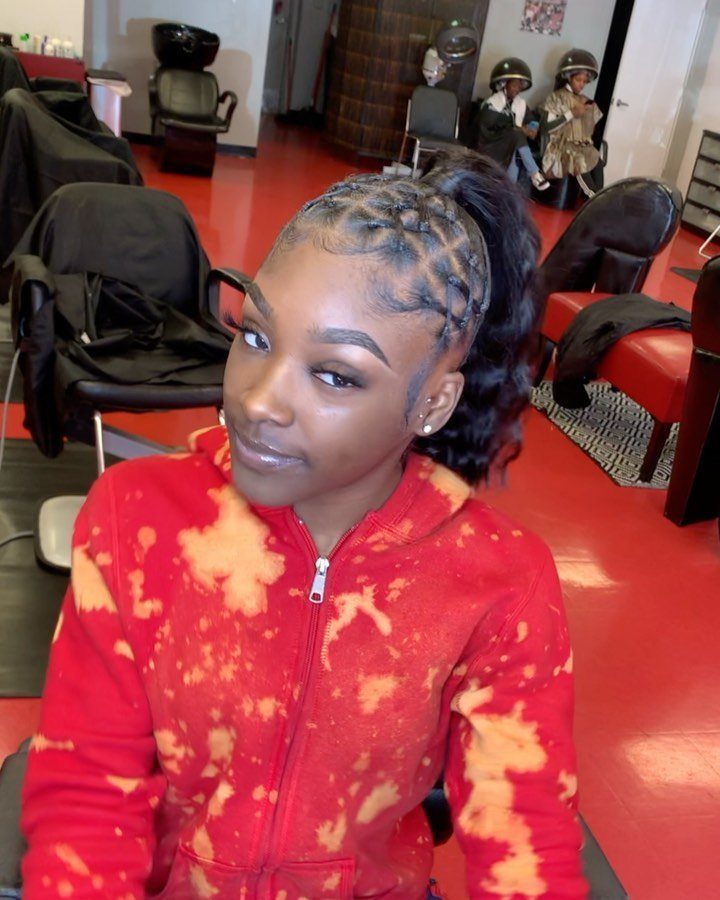 Woman with a criss-cross rubber band ponytail wearing a red tie-dye hoodie.